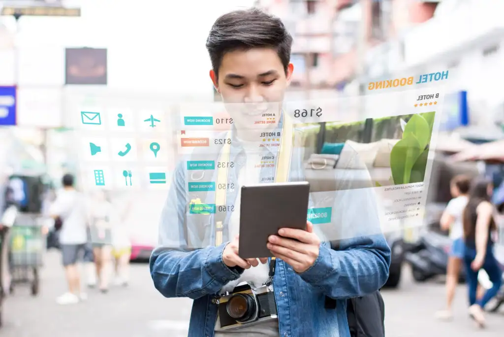Man tracking hotel prices on iPad with augmented reality details