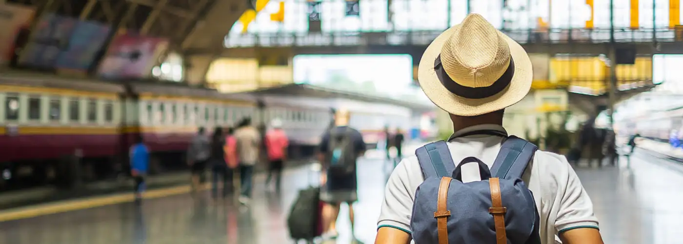 Man with backpack in train station