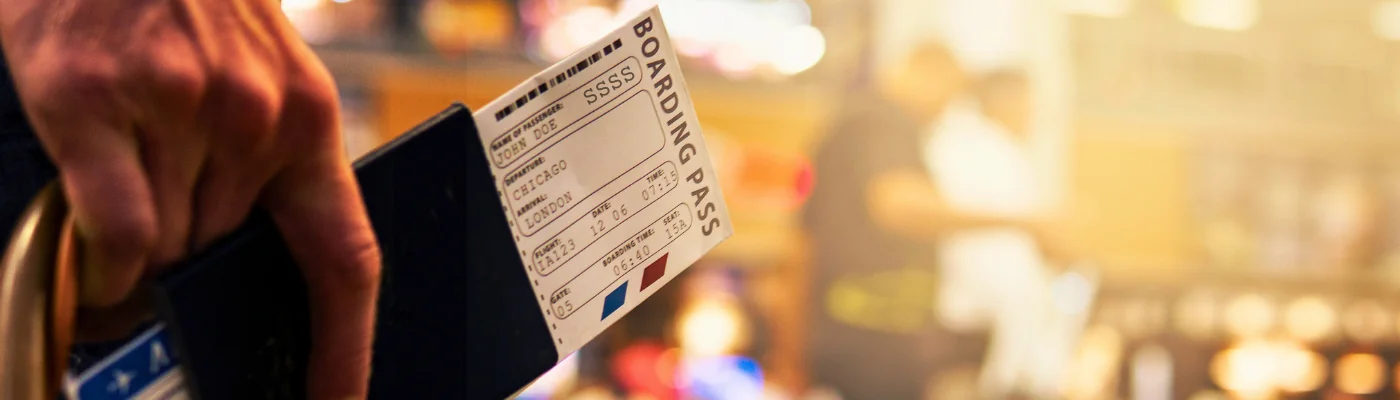Boarding Pass Close Up In Crowded Airport Terminal