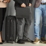 Business people in suits and smart casual clothes standing in line at the airport, waiting for boarding
