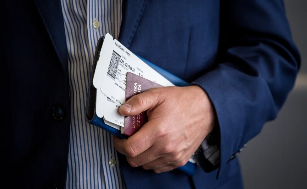 Businessman with passport and boarding pass at the airport