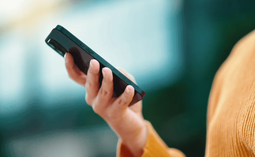 Closeup female handling cell phone
