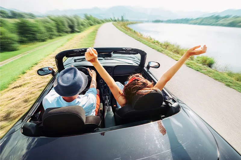 Couple riding in convertible