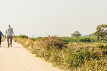 Elderly couple in love walking on a dust road, Portugal
