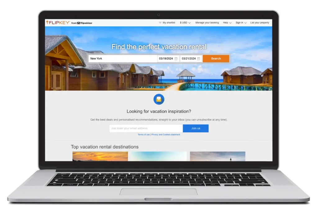 Open laptop showing the vacation rental search homepage for FlipKey