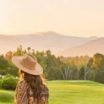 Woman with hat looking out over the grounds of the Mountain View Grand Resort and Spa