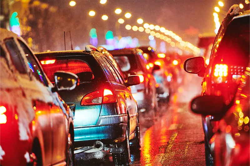 Blurry red lights of cars sitting in traffic at night
