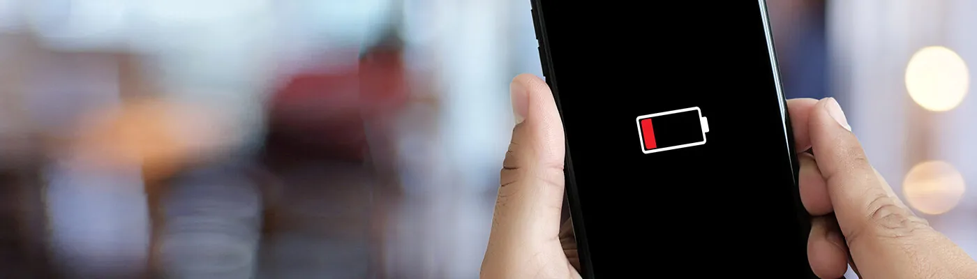Close up of smartphone with low battery warning