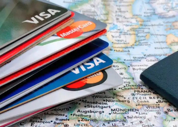 passport and credit cards on map.
