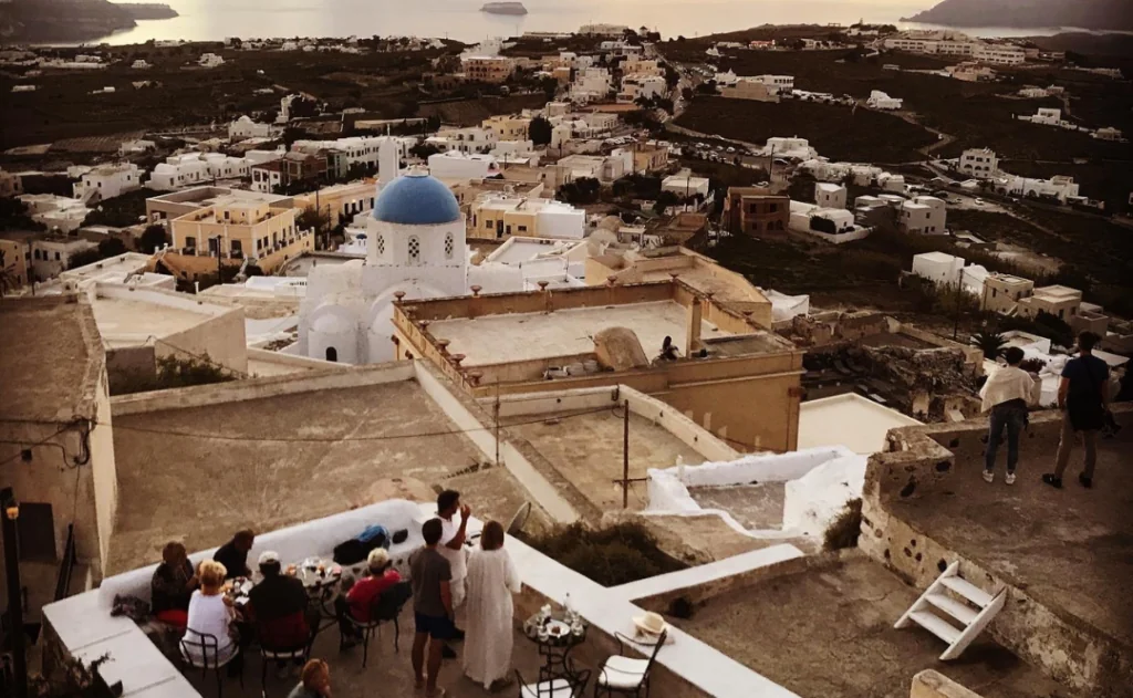 People eating on a scenic outlook in Santorini