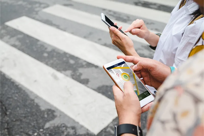 Two people navigating with their phone maps app