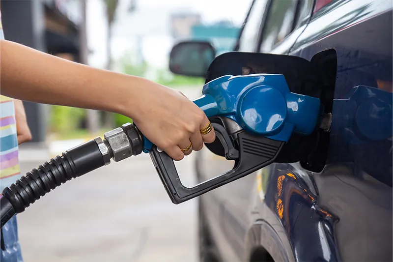 Close up of someone putting gas in their car