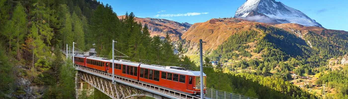 Zermatt, Switzerland. Gornergrat red tourist train on the bridge and Matterhorn peak panorama in Swiss Alps, benner