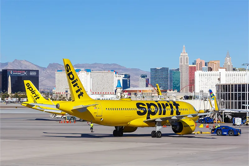 Spirit Airlines plane on runway at terminal