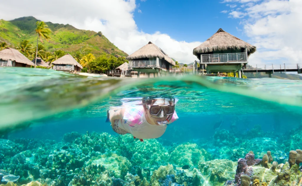 Woman snorkeling at coral reef in Bora Bora, French Polynesia