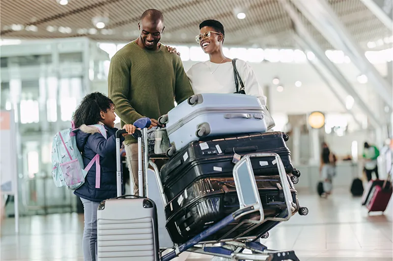 Young family transporting their luggage at an airport